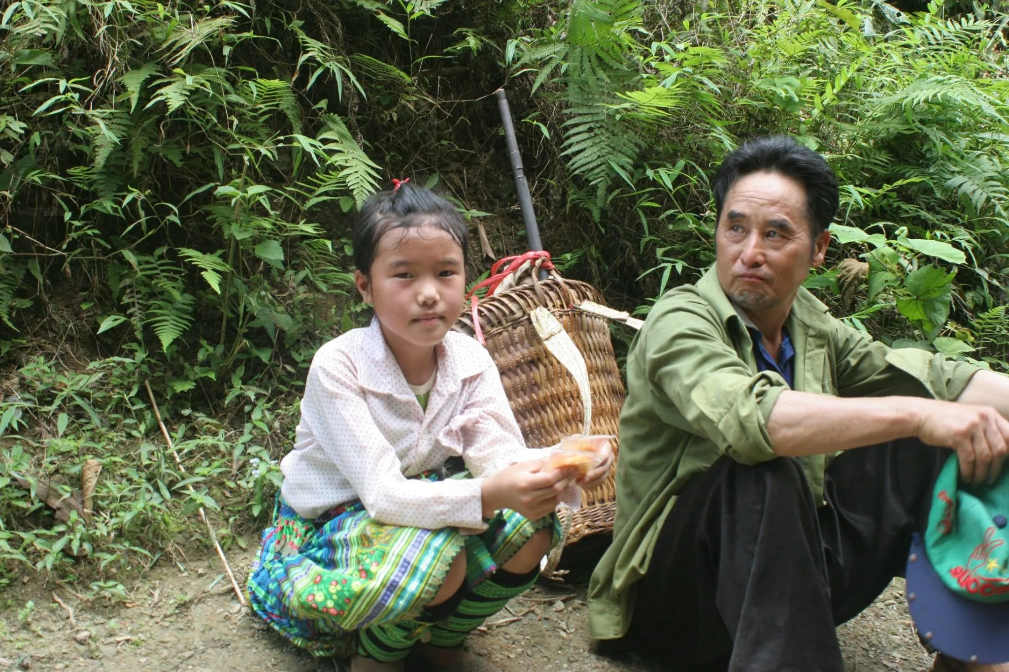 A girl and her father sitting together in a village in northern Vietnam