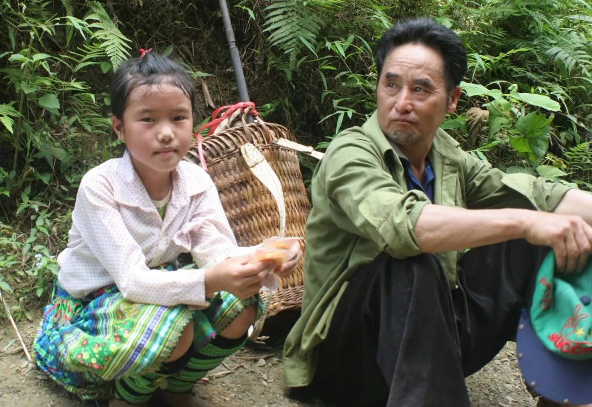 A girl and her father in a village in northern Vietnam