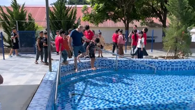 Headed into Van Ho’s very first children’s community swimming pool. The kids can’t believe it.